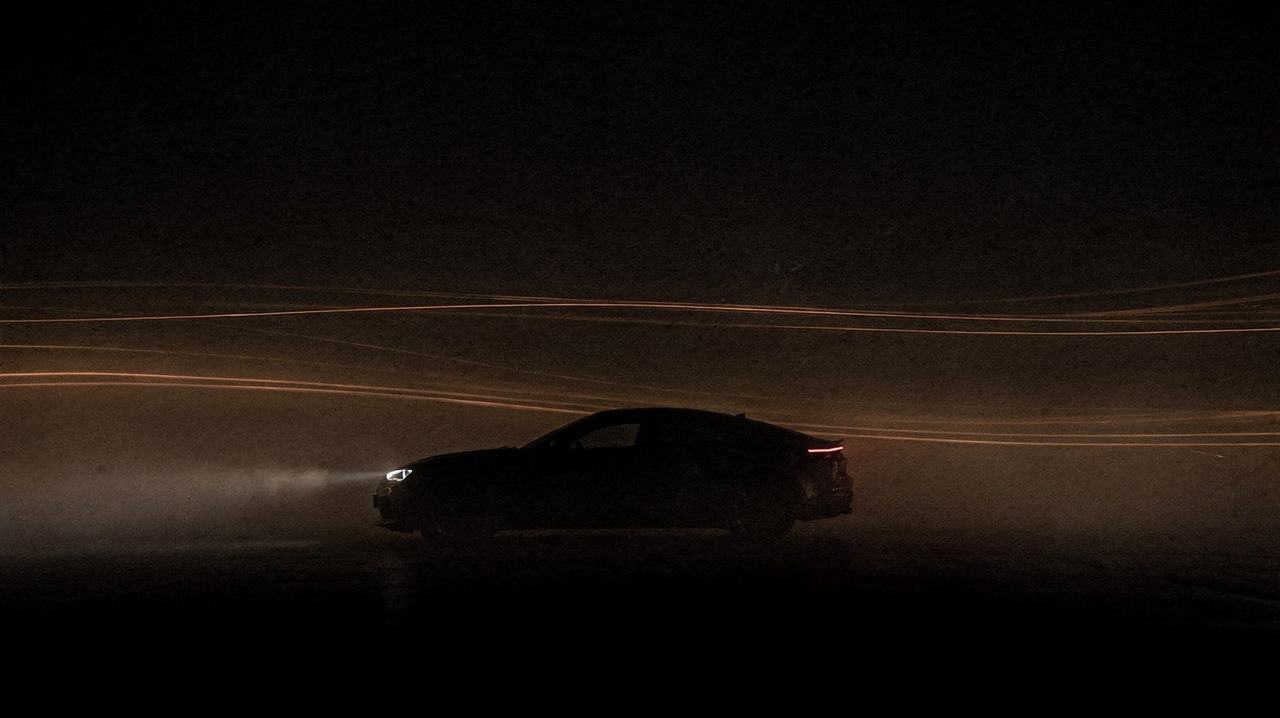 Chapter still — car silhouette in fog, light trails